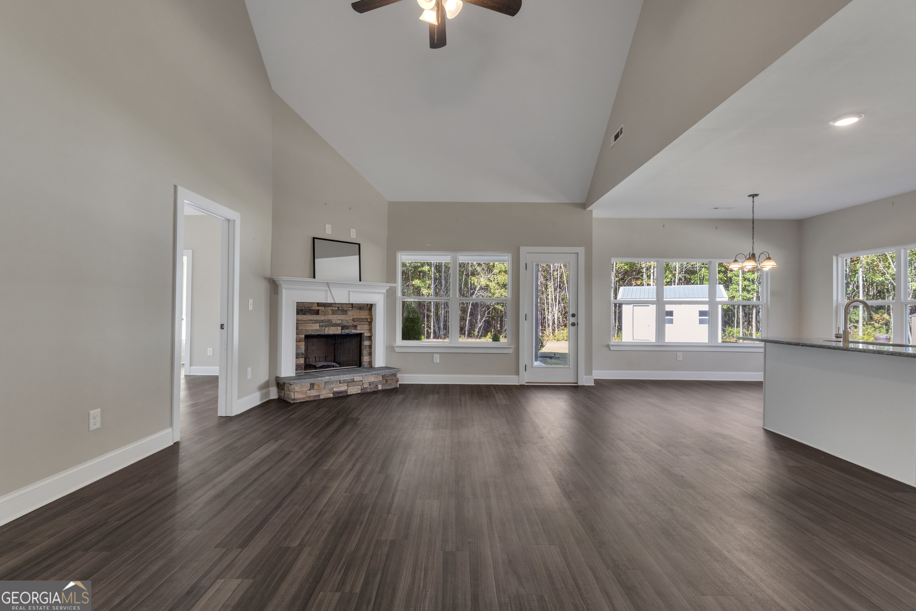 2114 Allie Road Greenville, GA 30222 - Photo 12 of 48 an empty room with fireplace wooden floor and windows