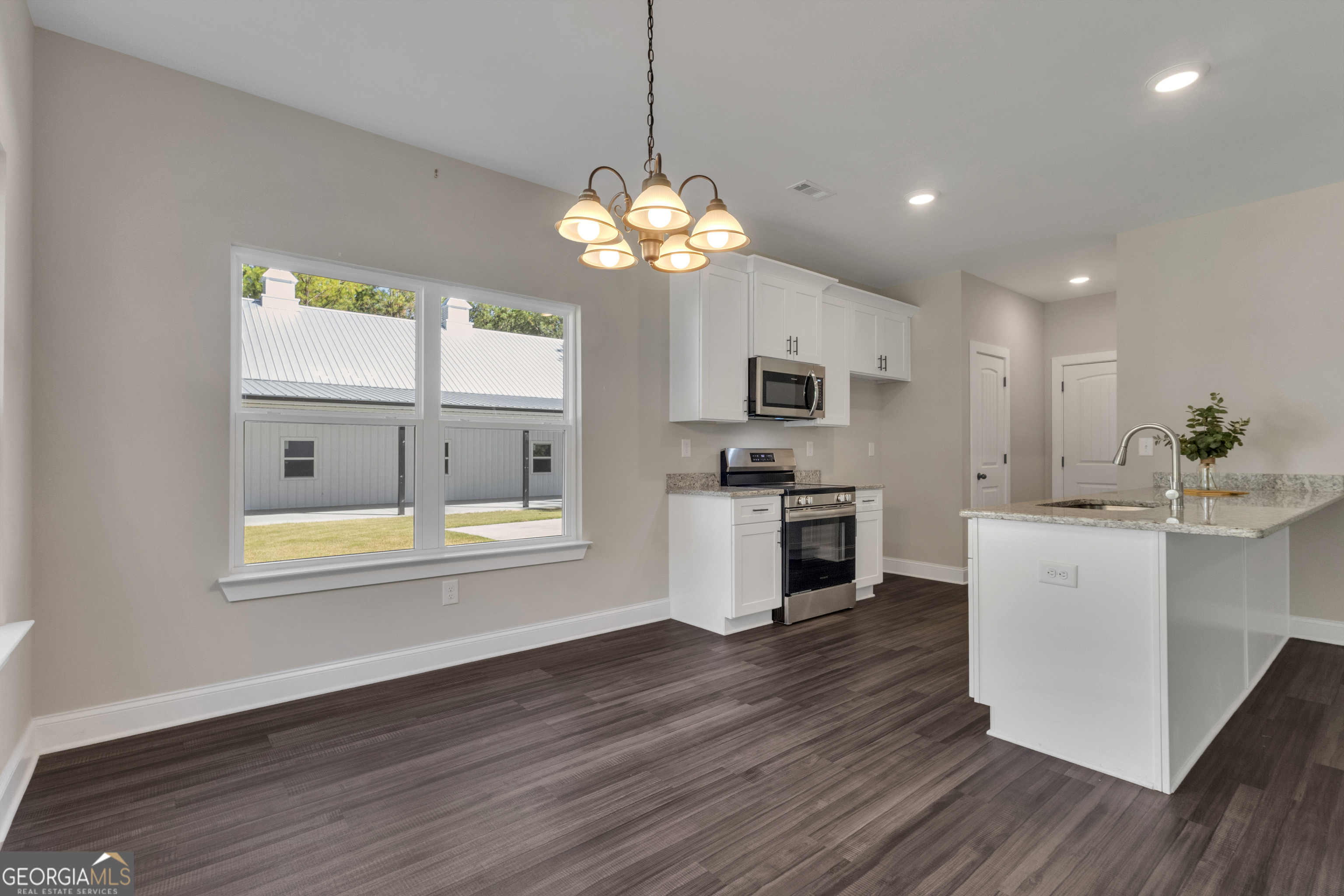 2114 Allie Road Greenville, GA 30222 - Photo 15 of 48 a kitchen with stove and wooden floor