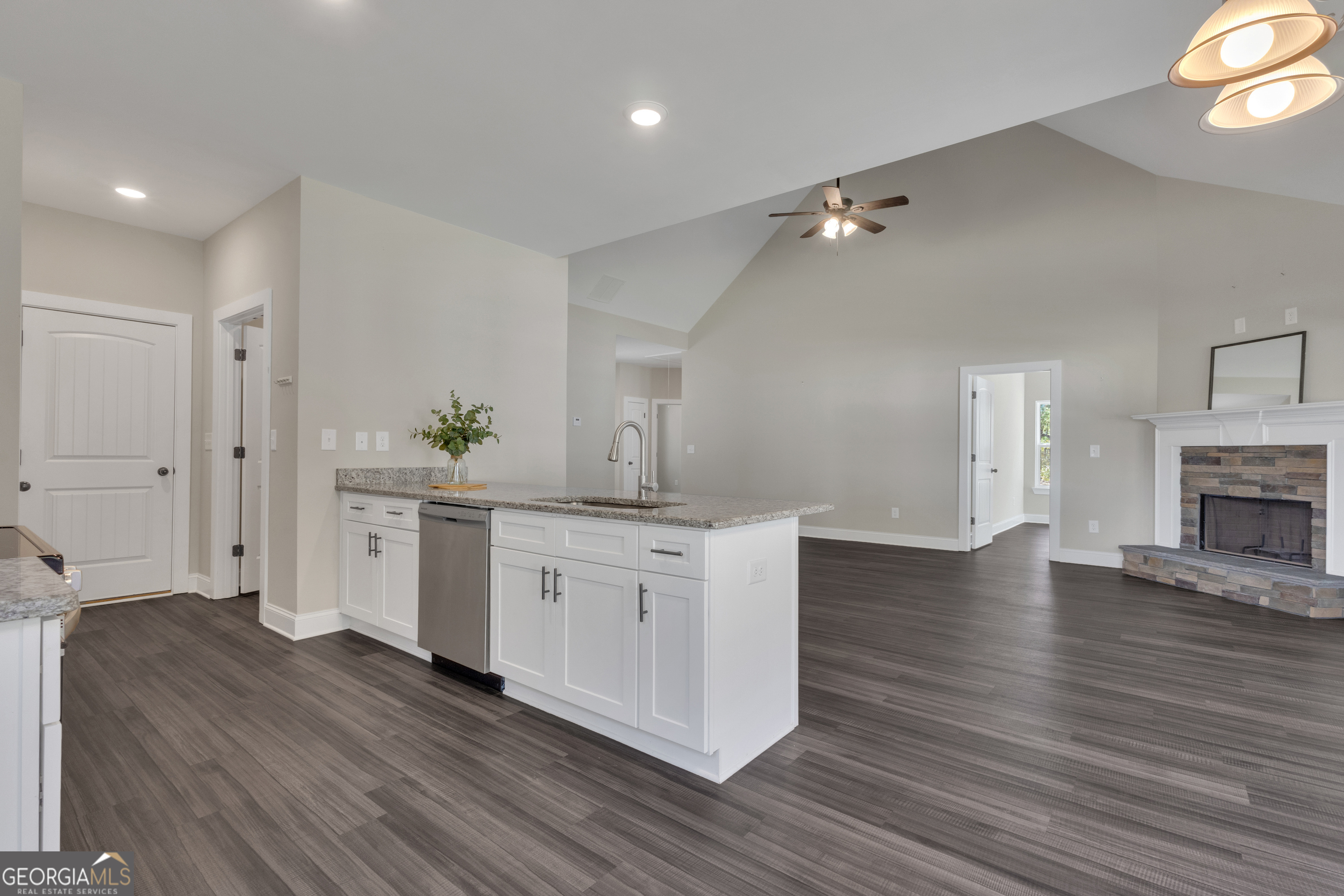 2114 Allie Road Greenville, GA 30222 - Photo 16 of 48 a kitchen with white cabinets and a fireplace