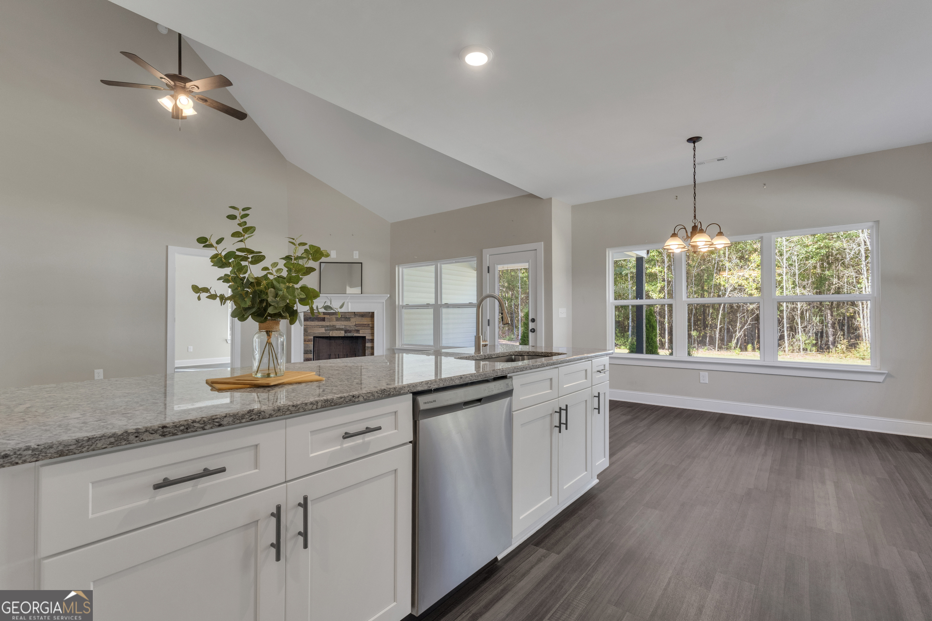 2114 Allie Road Greenville, GA 30222 - Photo 18 of 48 a large white kitchen with granite countertop a dishwasher a stove a dining table and chairs