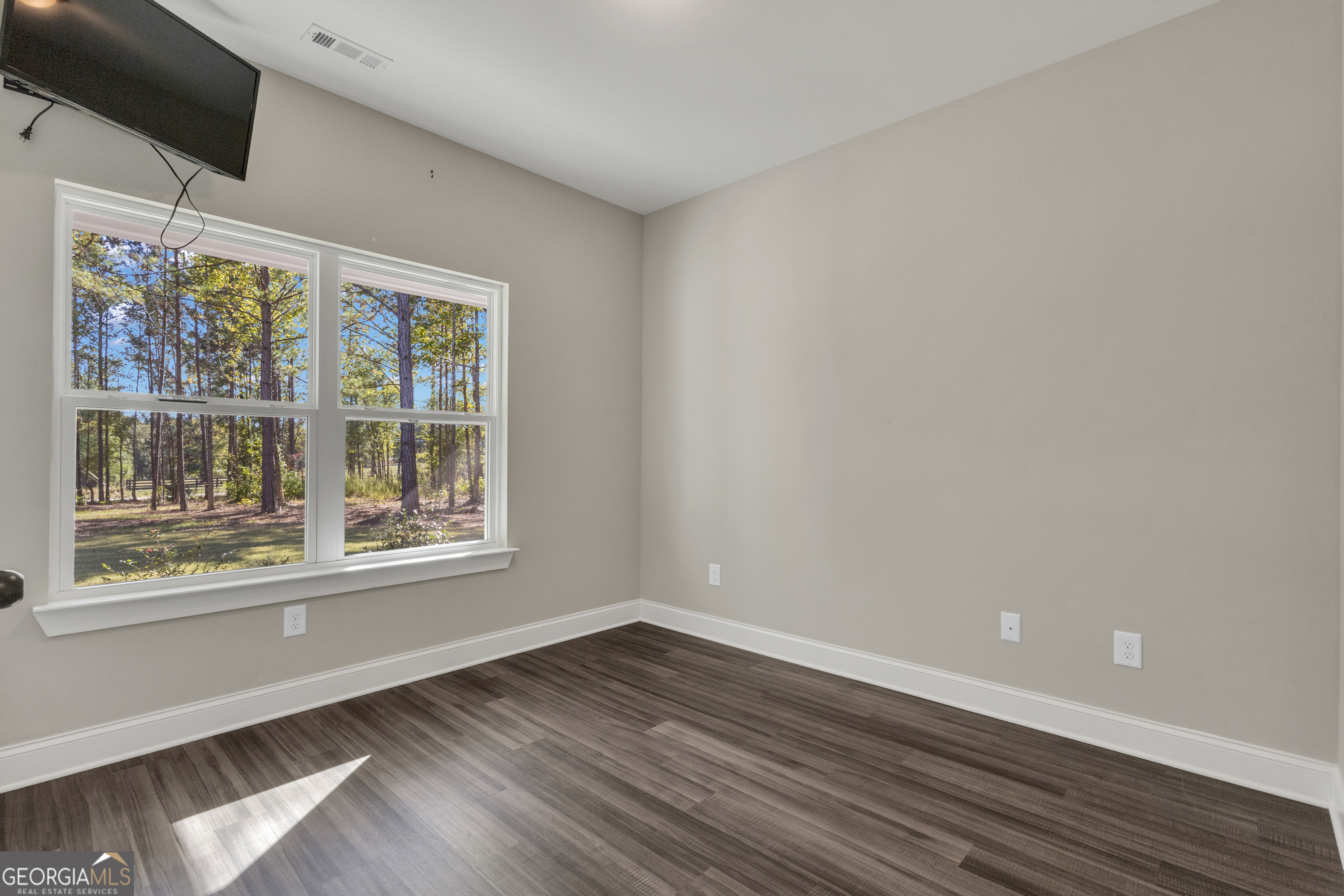 2114 Allie Road Greenville, GA 30222 - Photo 26 of 48 an empty room with wooden floor and windows