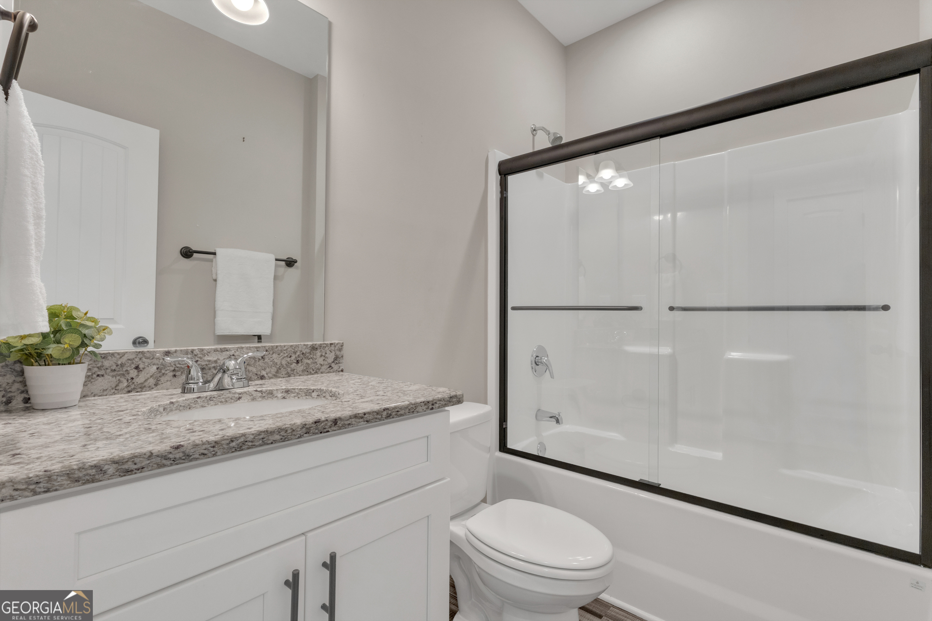 2114 Allie Road Greenville, GA 30222 - Photo 27 of 48 a bathroom with a granite countertop sink mirror vanity and toilet