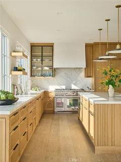 a living room with furniture large windows and a fireplace
