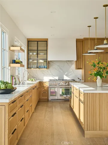 a living room with furniture large windows and a fireplace