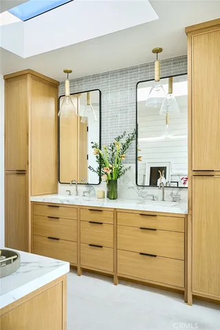 a spacious bathroom with a granite countertop sink mirror and a bathtub