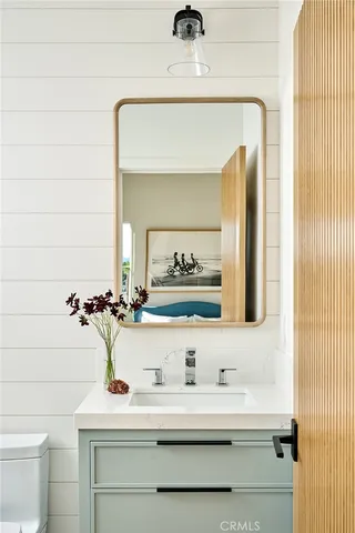 a bedroom with a large bed and windows