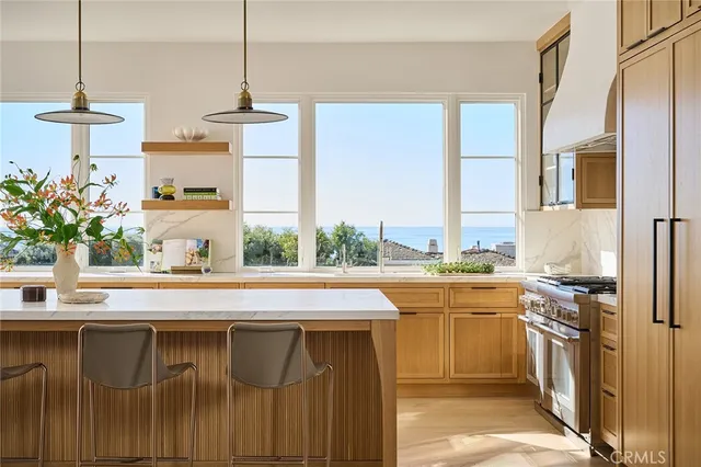 a kitchen with a sink a stove and a window