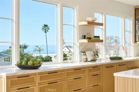 a kitchen with stainless steel appliances kitchen island granite countertop a table and chairs in it