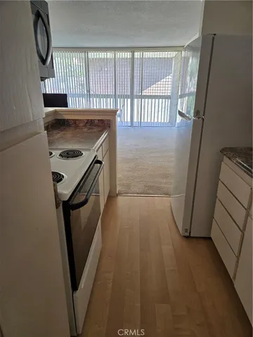 a view of a kitchen from a hallway
