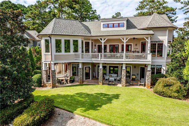 a dining room with furniture a chandelier and wooden floor