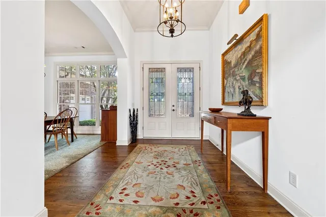 a view of an entryway with wooden floor and a bathroom