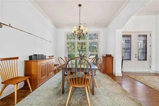 a view of staircase with lots of frames on wall and wooden floor