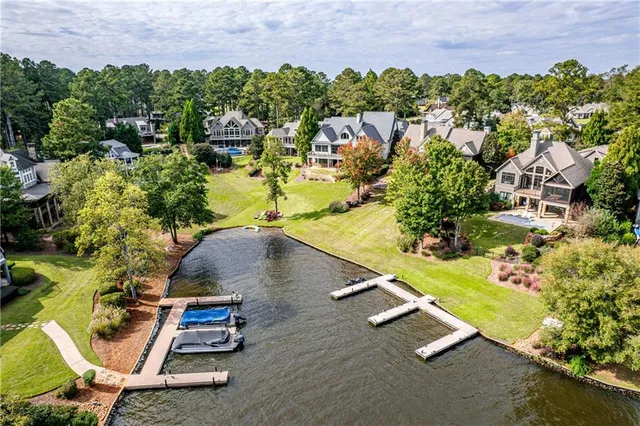 a swimming pool with outdoor seating and yard