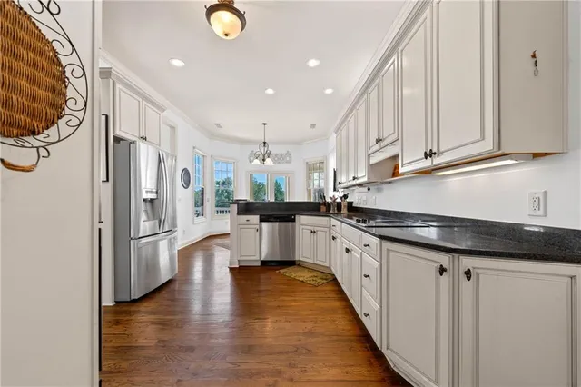 a bedroom with two beds and a chandelier