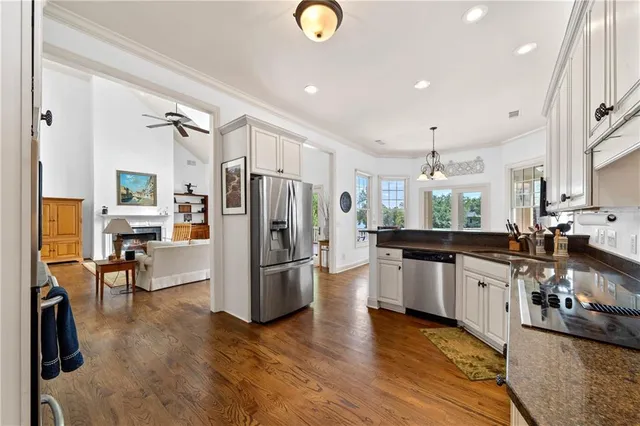 a living room with furniture a flat screen tv and a table