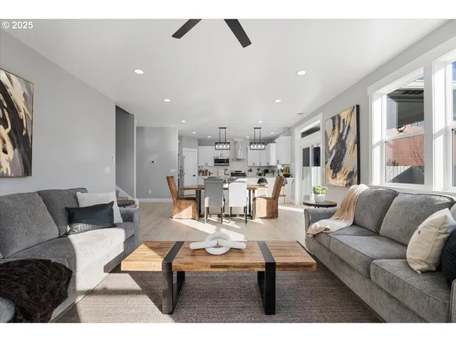 a living room with furniture and kitchen view