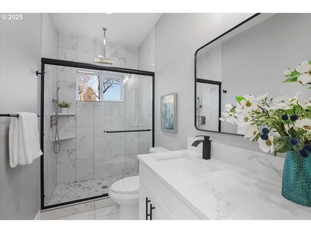 a bathroom with a toilet sink and shower