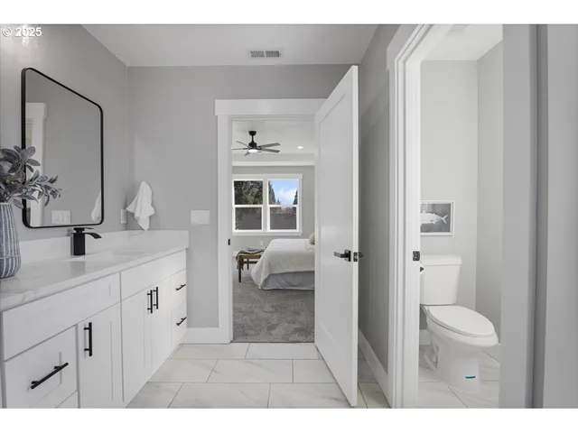 a bathroom with a sink a toilet and a mirror