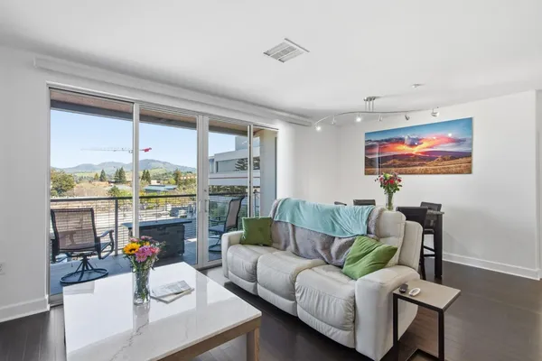 a living room with furniture and a floor to ceiling window