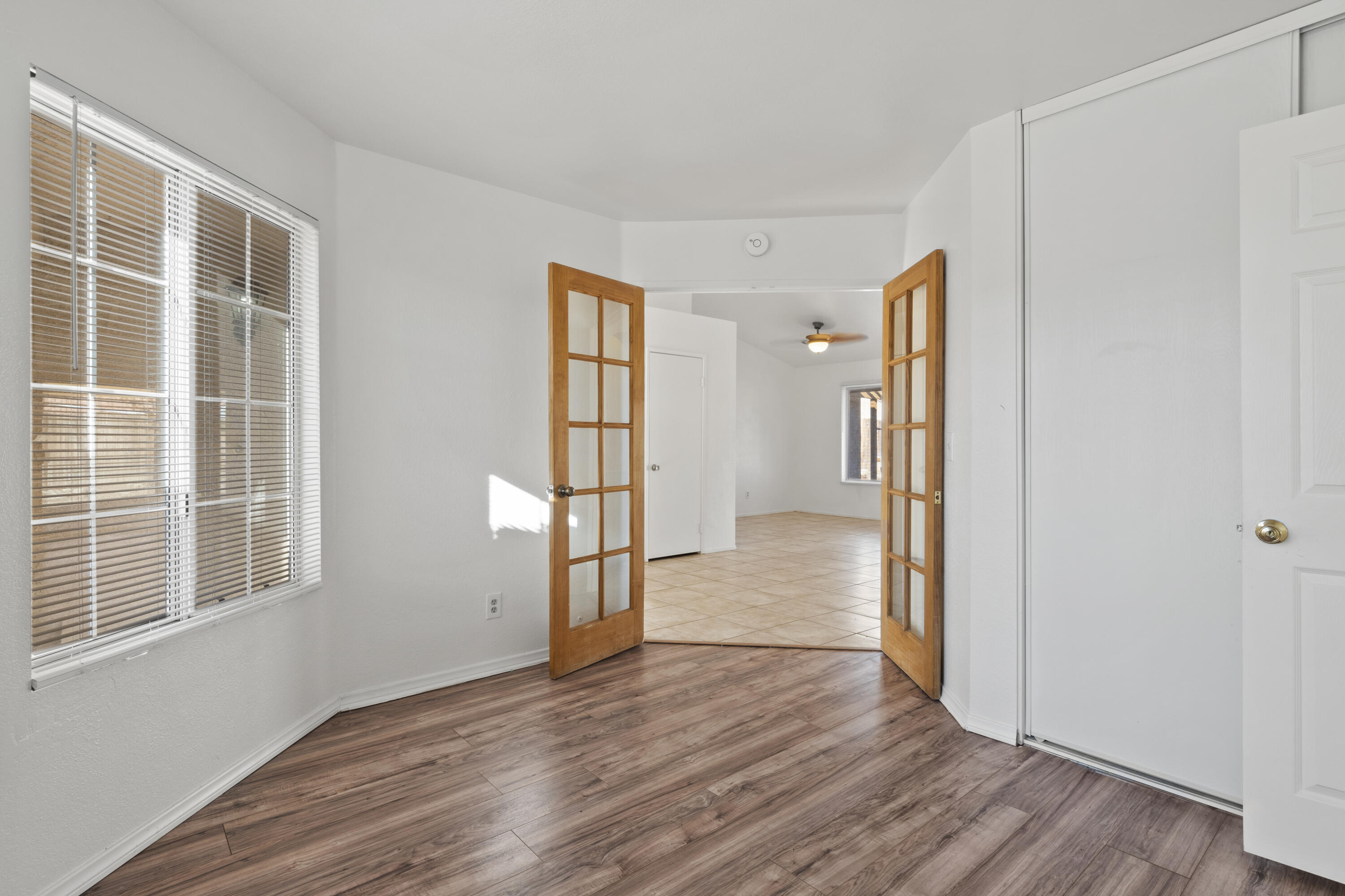 1551 Coventry Place Palmdale, CA 93551 - Photo 4 of 12 a view of empty room with wooden floor and fan