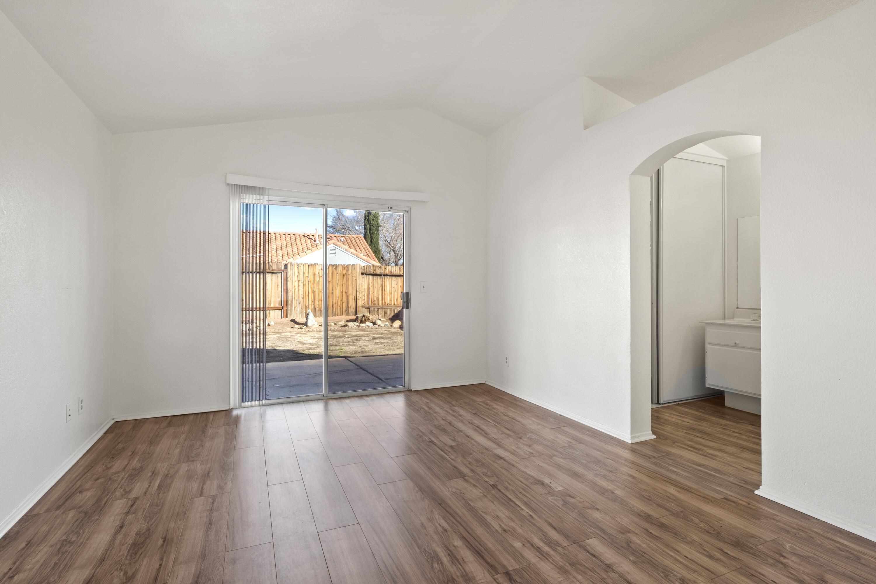 1551 Coventry Place Palmdale, CA 93551 - Photo 9 of 12 an empty room with wooden floor and windows