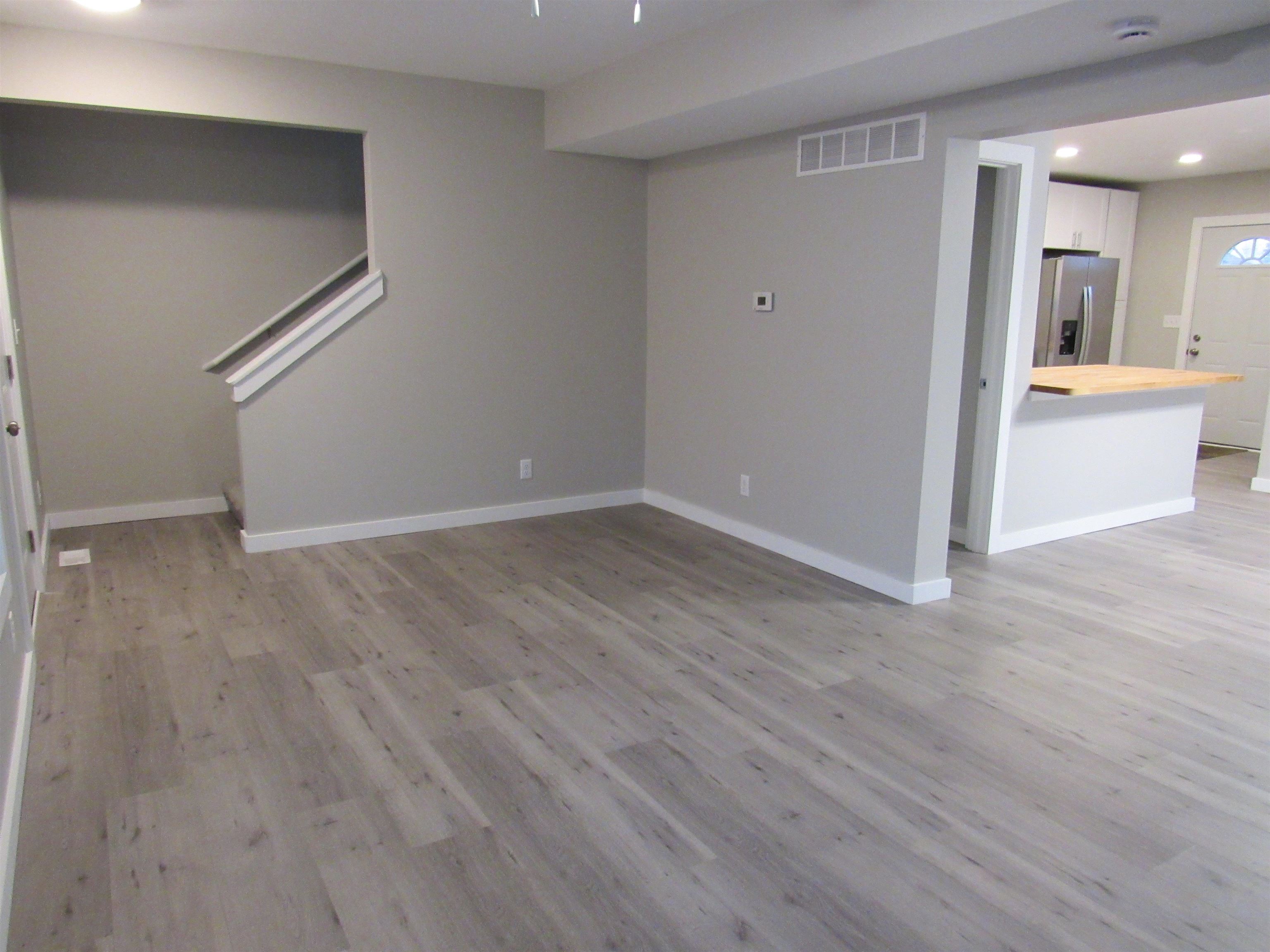 336 Belteberg Road Loves Park, IL 61111 - Photo 3 of 23 wooden floor in an empty room with a window