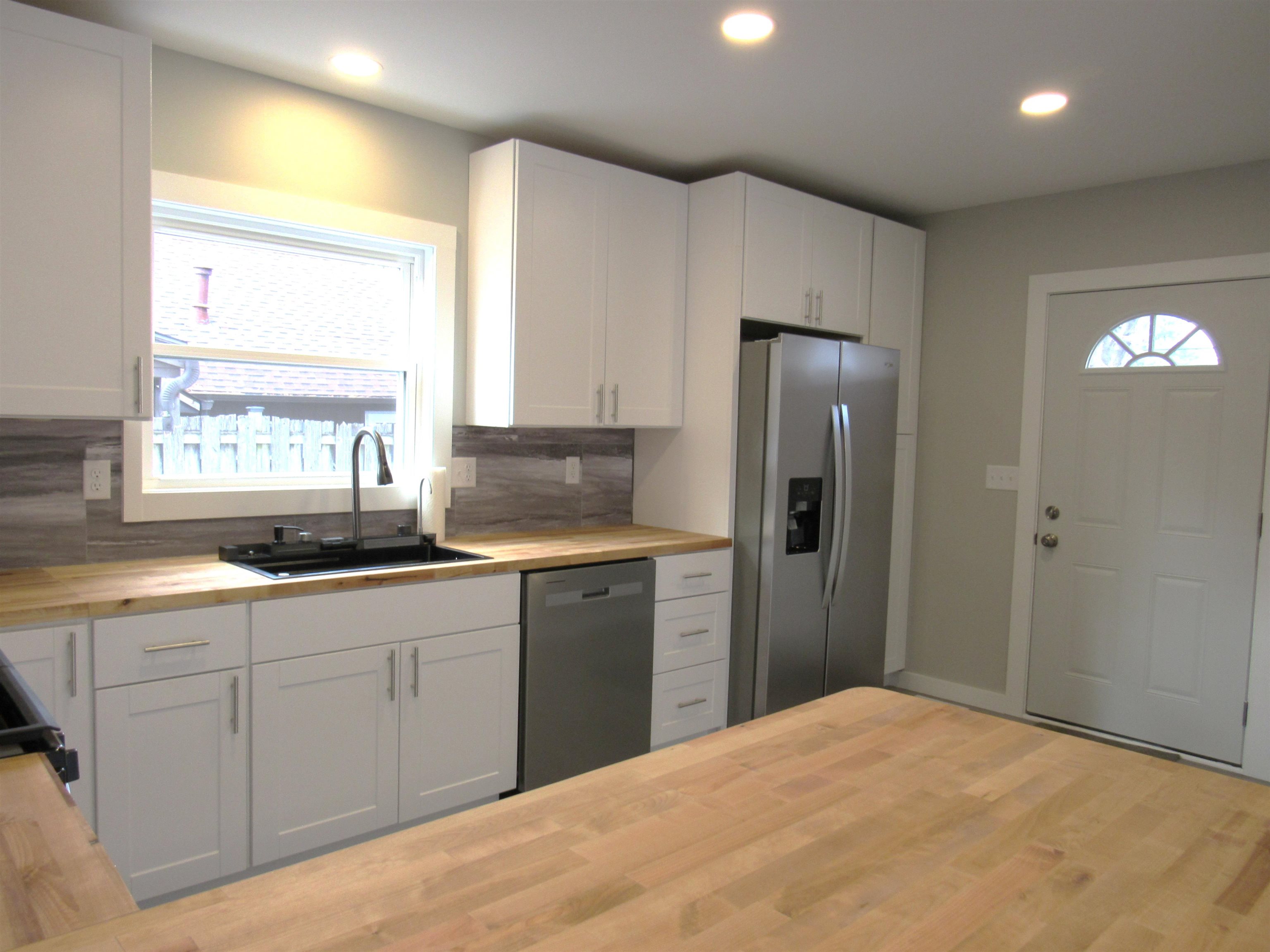 336 Belteberg Road Loves Park, IL 61111 - Photo 5 of 23 a kitchen with a sink a refrigerator and window