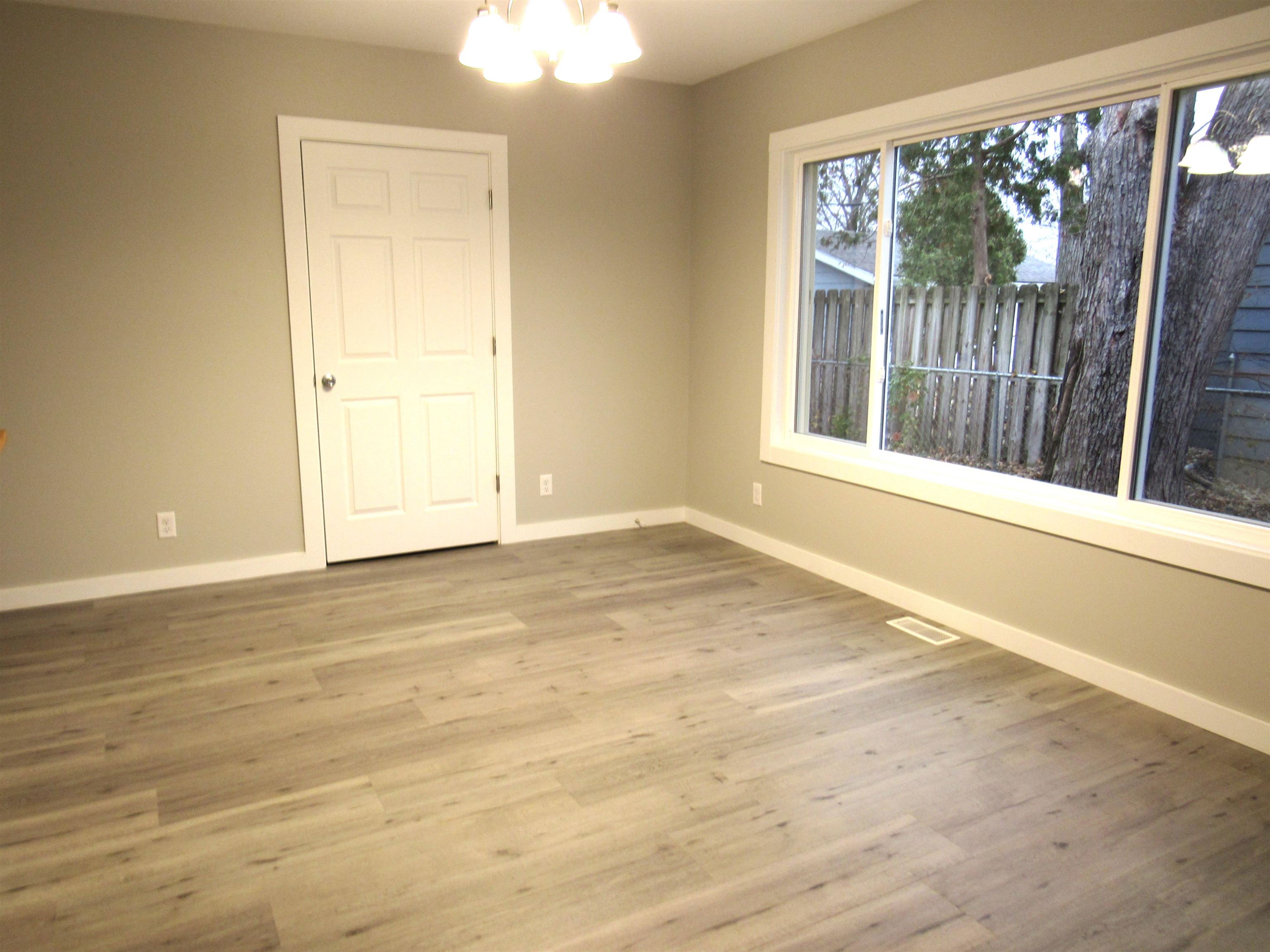 336 Belteberg Road Loves Park, IL 61111 - Photo 8 of 23 a view of an empty room with wooden floor and a window