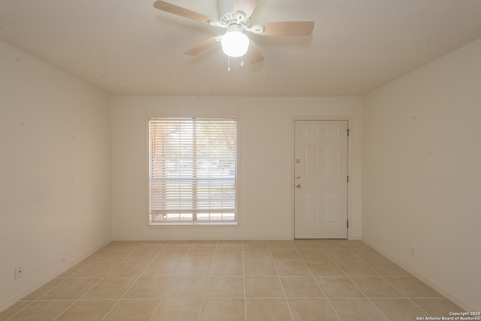 8914 Timber Run San Antonio, TX 78250 - Photo 3 of 23 an empty room with windows and fan