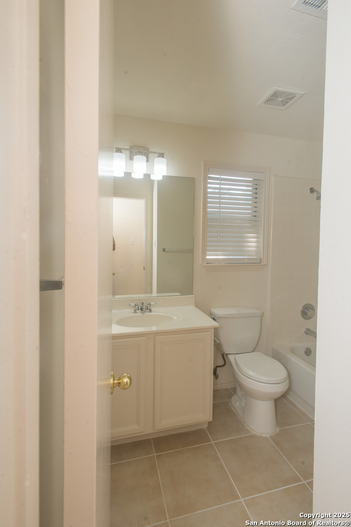 8914 Timber Run San Antonio, TX 78250 - Photo 5 of 23 a bathroom with a sink a toilet and a mirror