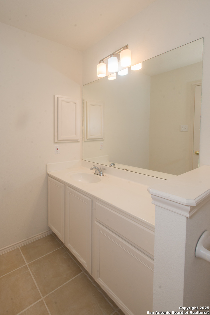 8914 Timber Run San Antonio, TX 78250 - Photo 10 of 23 a bathroom with a sink vanity and a mirror