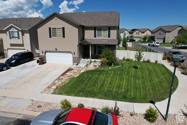 1973 Revere Way Eagle Mountain, UT 84005 - Photo 1 of 1 View of front of home with a garage and a front yard