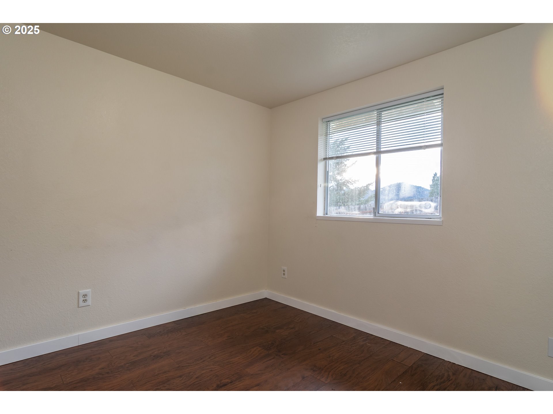 341 Ash Street Sutherlin, OR 97479 - Photo 15 of 28 an empty room with wooden floor and windows