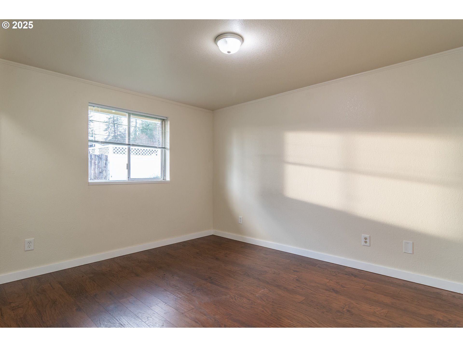 341 Ash Street Sutherlin, OR 97479 - Photo 19 of 28 an empty room with wooden floor and windows