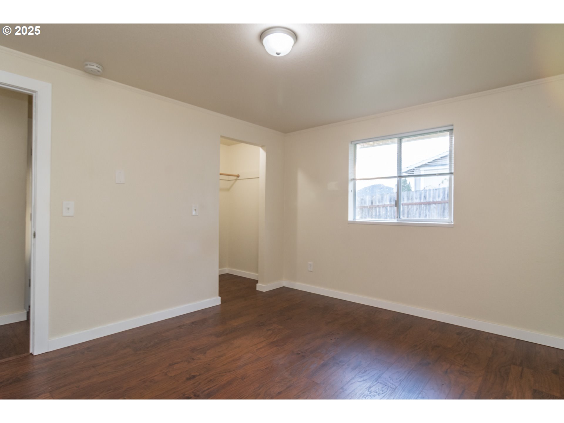 341 Ash Street Sutherlin, OR 97479 - Photo 20 of 28 an empty room with wooden floor and windows