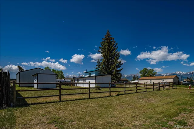 a bedroom with a bed and a refrigerator