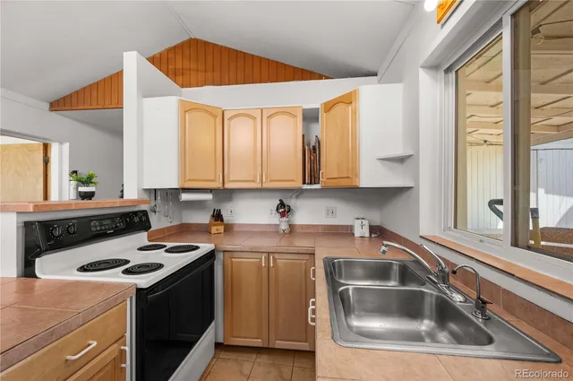 a kitchen that has a sink and a stove