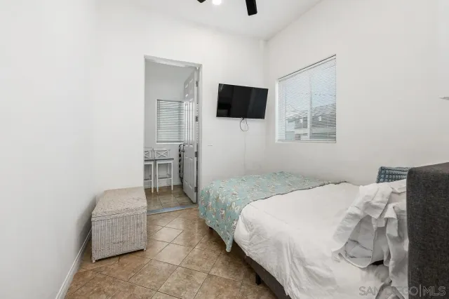 a bedroom with a bed and a television