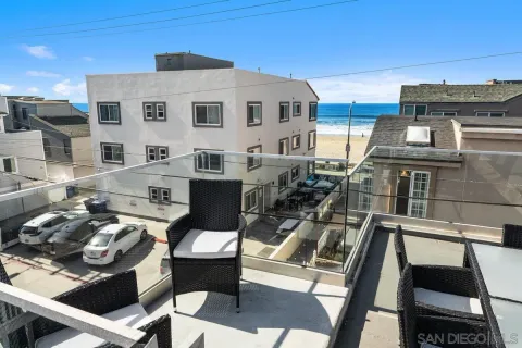 a front view of a house with outdoor seating