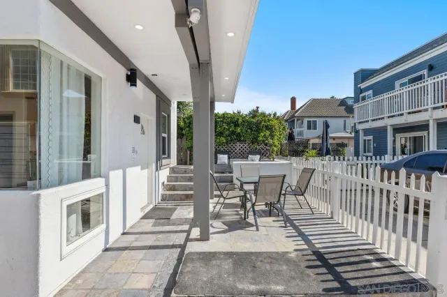 a view of a patio with couches table and chairs and potted plants