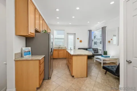 a kitchen that has a lot of cabinets and refrigerator