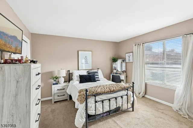 a bedroom with furniture and a window