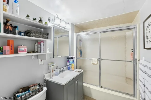 a bathroom with a sink vanity and tub