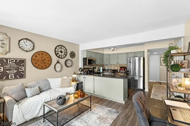 a living room with furniture and kitchen view