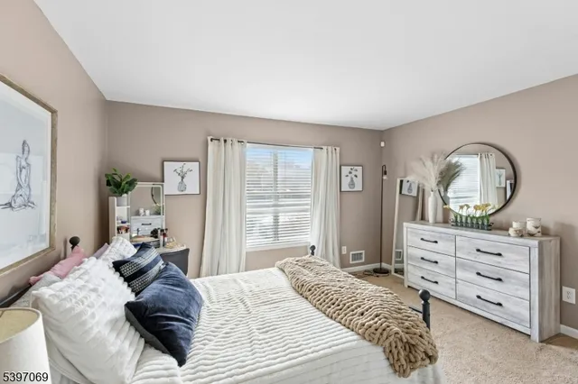 a bedroom with a bed and a dresser