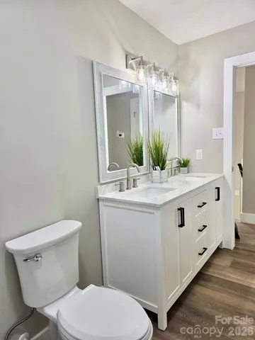 a bathroom with a double vanity sink and a mirror