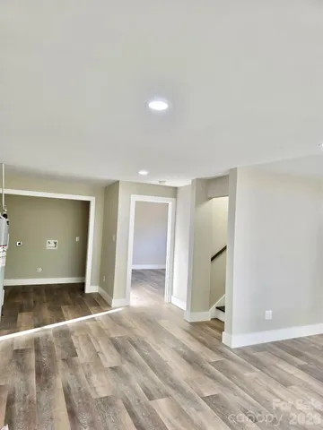 an empty room with a bathroom and closet area