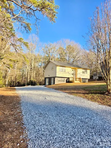 a view of big yard with large trees