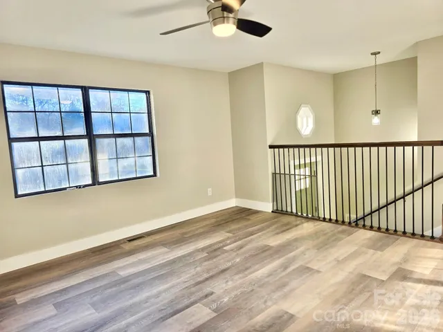 a view of a livingroom with a ceiling fan and window