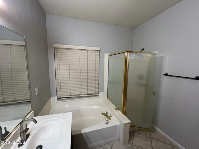 a bathroom with a tub sink and shower